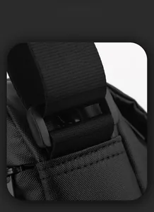 Detail of durable black nylon fabric texture and adjustable buckle on the shoulder bag