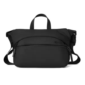 Minimalist black multi-pocket crossbody bag with top handle and textured nylon fabric