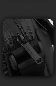 Macro view of water-resistant zipper detail on lightweight black crossbody shoulder bag