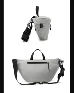 Detail of grey crossbody bag showing plastic buckle with logo and nylon strap texture