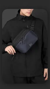 Close-up of durable oxford fabric texture and brand logo on waterproof crossbody bag
