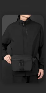 Close-up of a black high-density nylon crossbody bag with dual zippers and logo patch