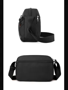 Detail view of the black canvas shoulder bag showing side profile and rear zip pocket