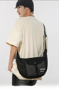 Detail view of the black waterproof nylon dumpling bag with a stylish buckle closure
