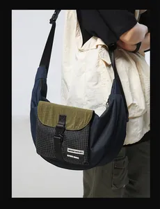 Detail of waterproof nylon dumpling bag with functional buckle and striped pocket
