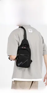 Back view of model wearing black casual chest bag with adjustable strap and grey logo