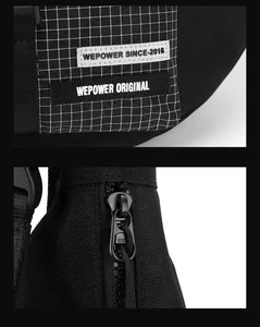 Detail of black canvas shoulder bag with branded logo patch and S8 zipper hardware