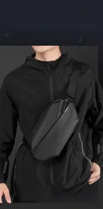 Detail of black crossbody chest bag with four-layer storage and waterproof matte texture