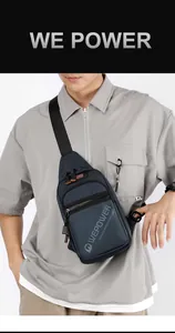 Detailed view of deep blue nylon sling bag with orange zip and adjustable strap