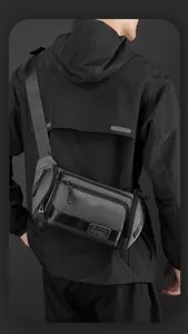 Rear view of a dark grey waterproof sling bag with wide adjustable shoulder straps