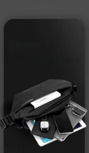 Detail view of black crossbody bag interior showing spacious multi-layer storage capacity