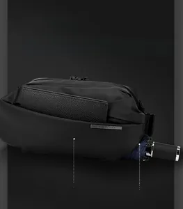 Close-up of black crossbody bag showing organized front pocket and side umbrella pocket