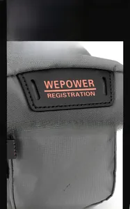 Close-up of the grey high-density fabric texture and WEPOWER logo label on the backpack