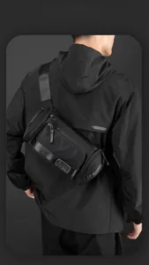 Detail of multi-compartment black outdoor sports waist bag with durable wide shoulder strap