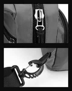 Detail of grey ripstop nylon fabric with metal zipper pull and swivel strap hook