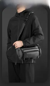 Detail showing high-density water-resistant nylon fabric and multiple zippers of the sling bag