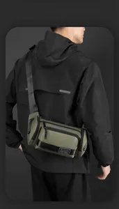 Detail of olive green waterproof sports chest bag with zipper pockets and WEPOWER logo