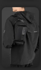 Detail of waterproof nylon waist bag showing multiple zipper pockets and brand strap