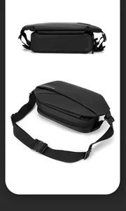 Detail view showing matte black fabric and quick-release buckle of this men's chest bag