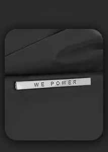 Detail of metal brand plate on black matte chest bag with smart storage texture
