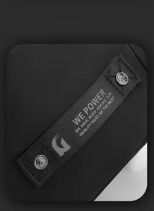 Close-up of black nylon canvas with silver metal rivets and WE POWER logo webbing