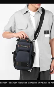 Detail of navy blue tactical chest bag with orange stitching and Wepower logo