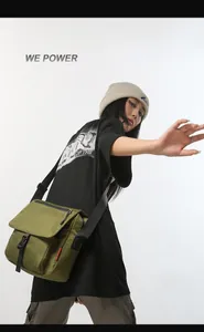 Detailed view of olive green tactical messenger bag with durable buckle and zipper