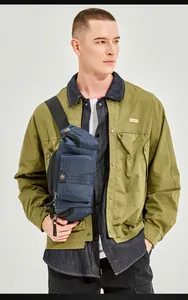 Detailed view of the dark blue multi-pocket outdoor crossbody bag worn by a model