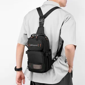 Men's multi-functional tactical chest bag in black durable fabric worn by a model