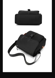 Detail of the black messenger bag with orange D-ring buckle and wide nylon strap