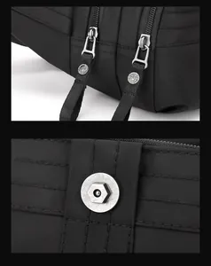 Detail of black nylon sports bag showing dual zippers and metal buckle hardware