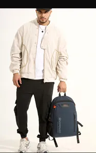 Man carrying a dark blue durable nylon backpack with orange contrast zippers for commuting