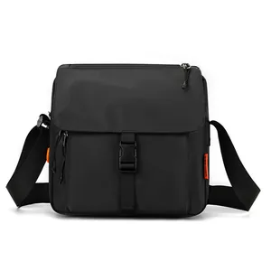 Waterproof nylon crossbody messenger bag in black with flap closure and orange brand tag