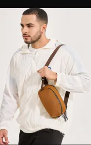Detail of tan sports chest bag featuring waterproof zipper and adjustable shoulder strap