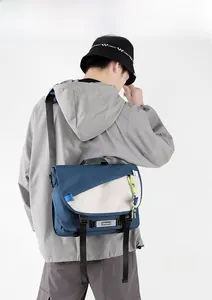 Rear view of a model wearing a grey and navy large capacity functional messenger bag
