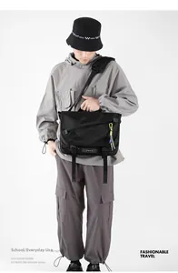 Detail of black waterproof messenger bag with fluorescent zipper cords and buckle strap