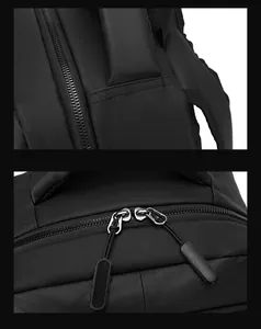 Detail of black nylon backpack with heavy-duty stitching and padded carrying handle