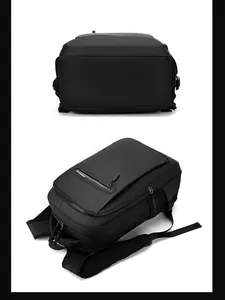 Detail view of black laptop backpack showing waterproof fabric and mesh shoulder straps