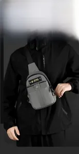 Detail view of the urban nylon chest bag showing zipper compartments and branding label