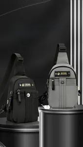 Close-up of durable black and grey crossbody chest bags displayed on a premium metal pedestal