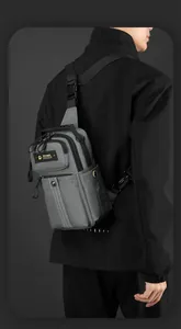 Detailed view of dark grey tactical chest bag with durable nylon material and zippers