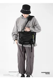 Close-up of black tactical messenger bag with nylon fabric and dual buckle closures