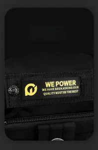 Detail view of black nylon shoulder bag with WEPOWER yellow logo and metallic embossed buttons