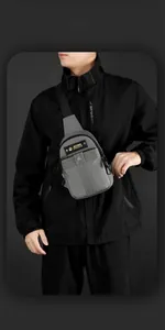 Detail of gray waterproof nylon crossbody chest bag with magnetic buckle and secure zipper
