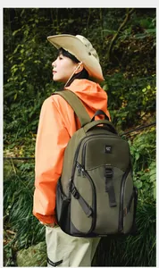 Close-up of olive green outdoor backpack with thick padded straps and multi-zipper pockets