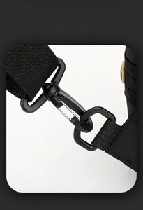 Detail of durable black swivel snap hook and nylon webbing strap on crossbody bag