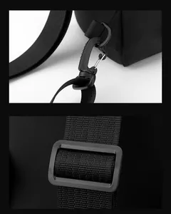 Detail of durable plastic buckle and adjustable shoulder strap on black nylon bag
