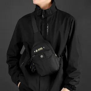 Men's compact black nylon crossbody sling bag with adjustable strap and front zipper pouch