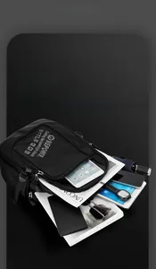 Detail view of the large capacity black backpack showing multi-layer storage compartments