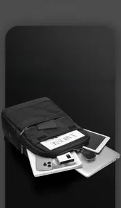Detailed interior of black business backpack showing multi-layer storage for laptop and gadgets